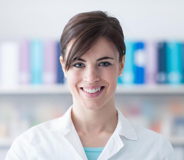 Smiling young doctor posing and looking at camera, healthcare professionals